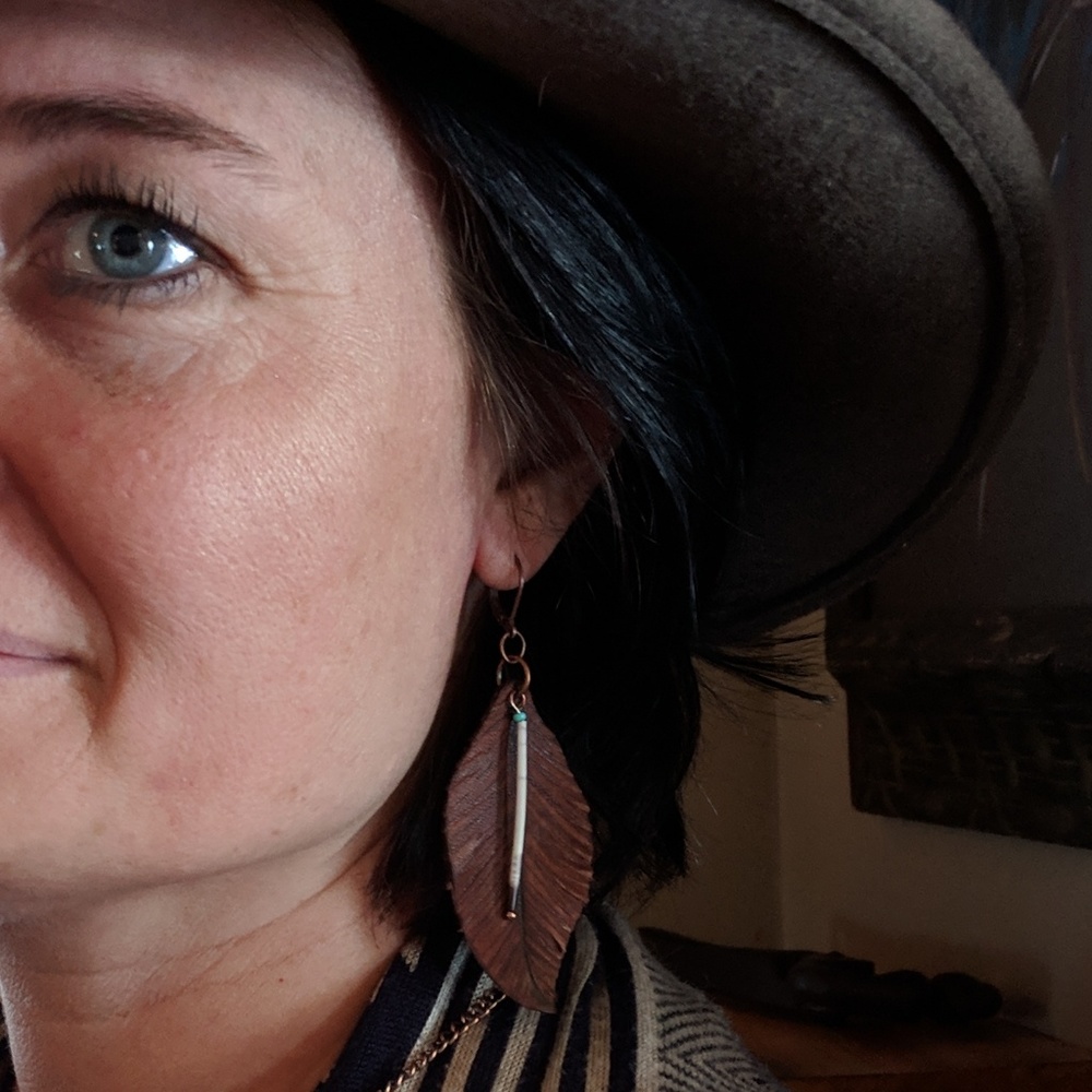 Leather feathers with porcupine quills.